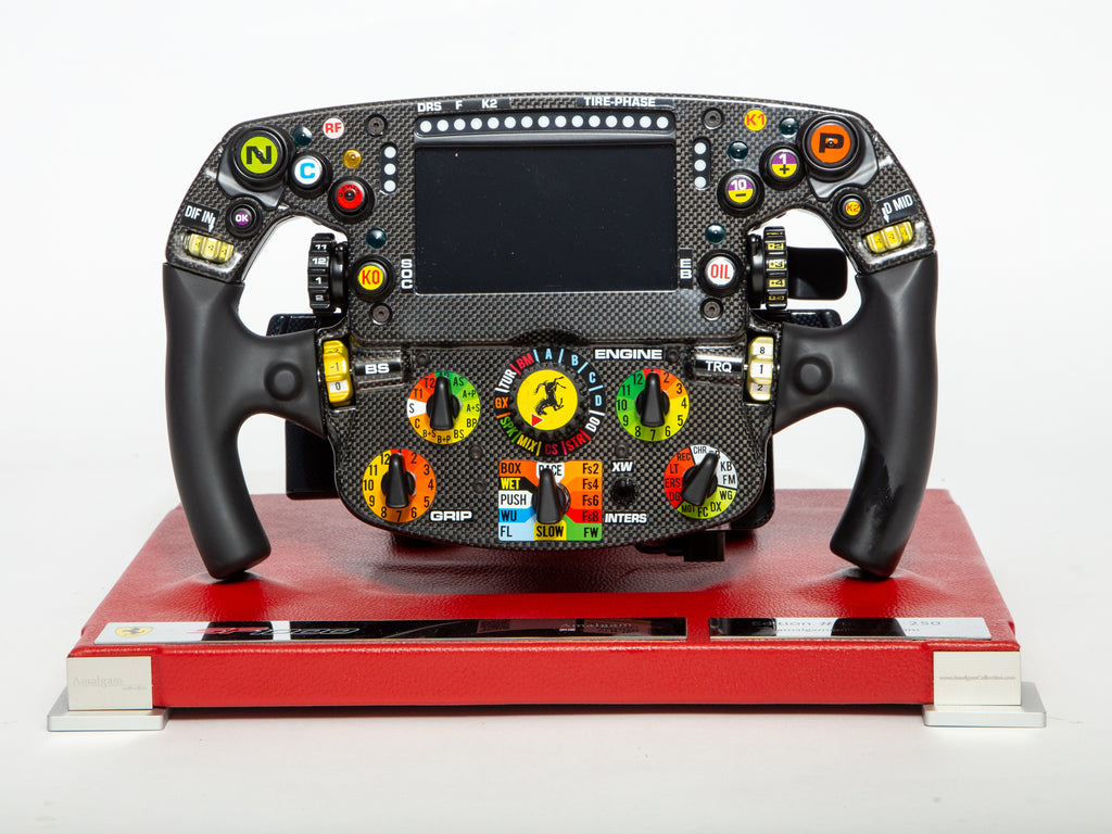 Ferrari Formula 1 steering wheel on a red platform with a white background